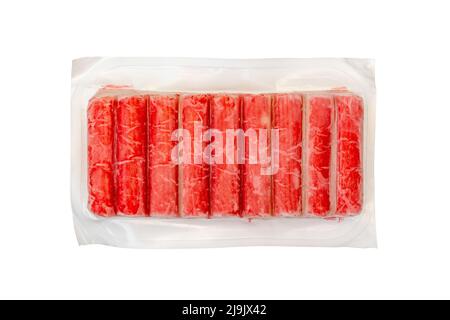 Frozen crab sticks in vacuum packing isolated on white background Stock Photo