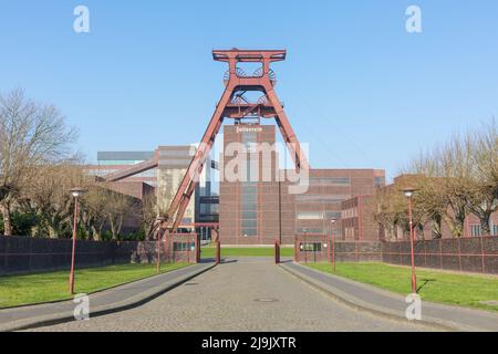 Essen, Germany - Mar 26, 2022: Taking a look through the entrance gate: The famous shaft tower of Zeche Zollverein. Stock Photo