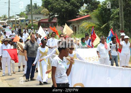 PUNTA GORDA, BELIZE - APRIL 20, 2016 Halal Intercessors march through the centre of town waving flags Stock Photo