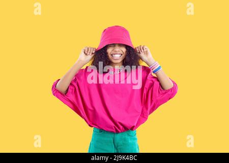 Happy Black girl in trendy casual outfit laughing and having fun in fashion studio Stock Photo