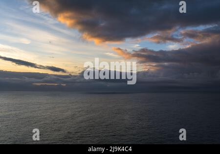 Dramatic sky over the sea at sunrise Stock Photo