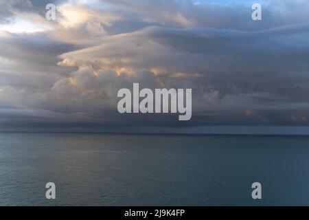 Dramatic sky over the sea at sunrise Stock Photo