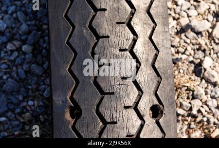a patterned tire that has been flattened to the ground Stock Photo