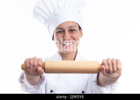 Happy caucasian woman dressed as chef showing kitchen utensil looking at camera isolated on white background. Stock Photo