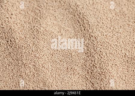 Active dry baking yeast granules background texture, top view. Stock Photo