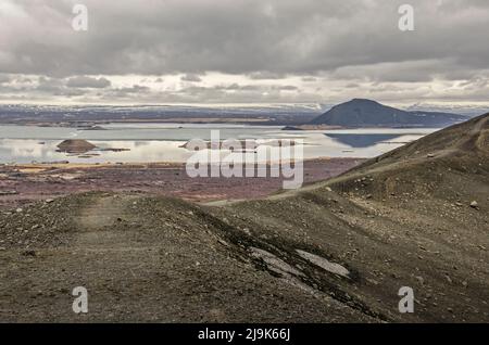 The hiking trail on the rim of Hverfjall crater in northern Iceland with the caldera on the right and lake Myvatn on the left side Stock Photo