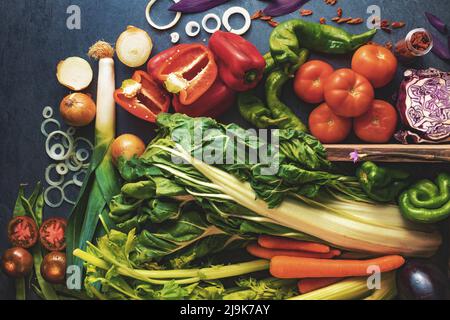 Healthy foods. Vegetables and fruits collection on black cement or stone background. Top view and copy space.Vegetarian food background. Stock Photo