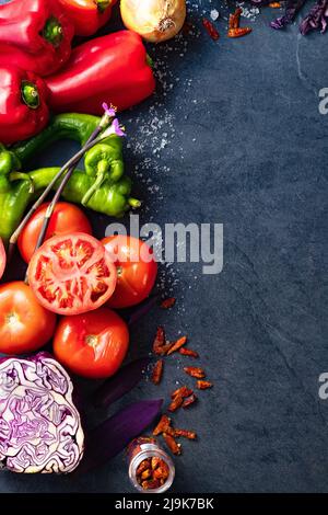 Healthy foods. Vegetables and fruits collection on black cement or stone background. Top view and copy space.Vegetarian food background. Stock Photo