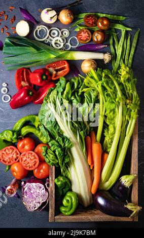 Healthy foods. Vegetables and fruits collection on black cement or stone background. Top view and copy space.Vegetarian food background. Stock Photo