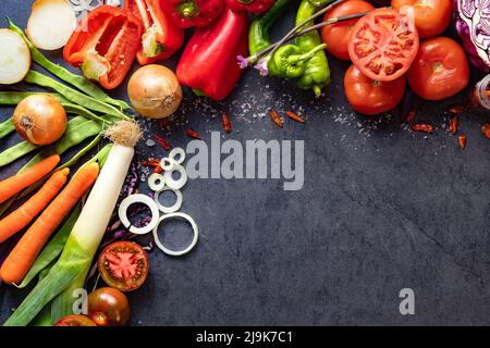 Healthy foods. Vegetables and fruits collection on black cement or stone background. Top view and copy space.Vegetarian food background. Stock Photo