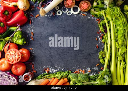 Healthy foods. Vegetables and fruits collection on black cement or stone background. Top view and copy space.Vegetarian food background. Stock Photo
