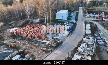 Pallets of bricks for construction. Outdoor storage. Warehousing of large quantities of bricks. Aerial view Stock Photo