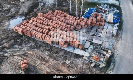 Pallets of bricks for construction. Outdoor storage. Warehousing of large quantities of bricks. Aerial view Stock Photo