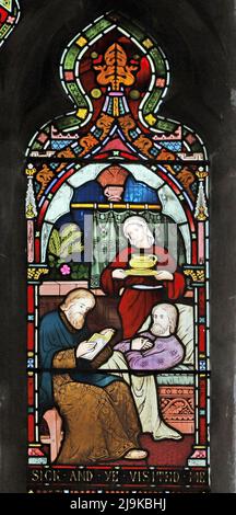 A stained glass window by Frederick Preedy depicting Corporal Acts of Mercy, St Peter and St Paul's Church, King's Sutton, Northamptonshire Stock Photo