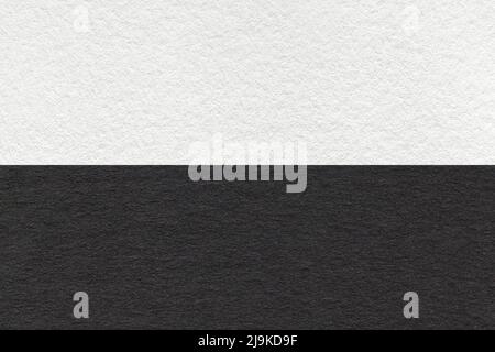 Texture of craft black and white paper background, half two colors, macro. Structure of vintage dense cardboard. Felt backdrop closeup. Stock Photo