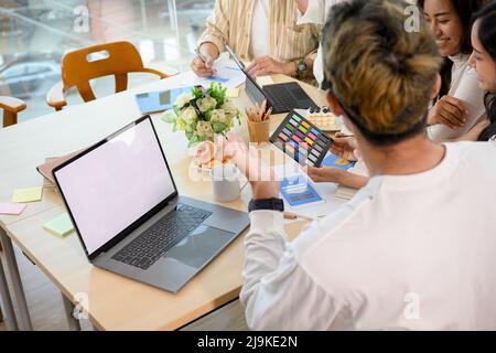 Close-up image, A team of graphic designers and web developers are discussing and planning the project together. Stock Photo
