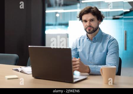 Portrait of business man using laptop and posing Stock Photo