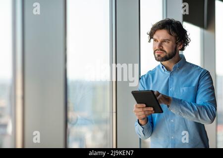 Portrait of man using digital tablet at office Stock Photo
