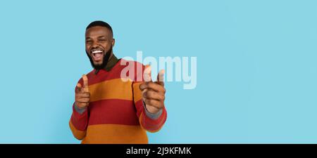 Gotcha. Cheerful Handsome Black Man Poiting At Camera With Two Hands, Millennial African American Male Indicating Somebody And Smiling, Having Fun On Stock Photo