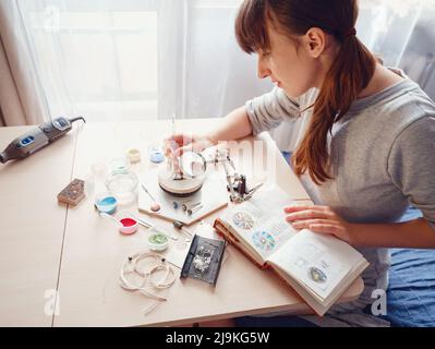 Lifestyle concept, work from home to reinvent your life - Jewelry designer workplace. Woman make jewelry. Georgian minankari enamel manufacturing tech Stock Photo