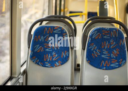 Seats on bus. Empty seats in transport. Seats for passengers. Interior of bus. Stock Photo