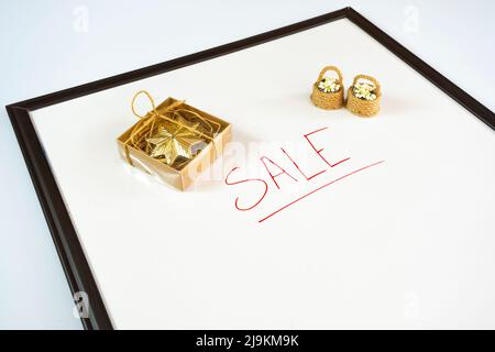 Sale text with red colour marker and gift box on a whiteboard, present idea, shopping concept, advertising banner for e-commerce, copy space Stock Photo