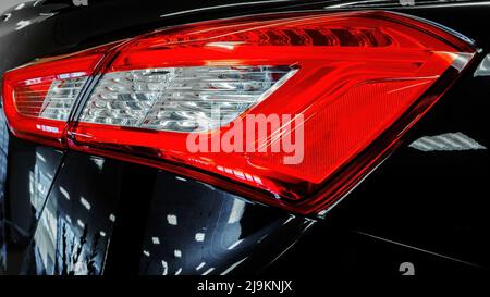 Taillight modern car. Close-up. Black, Red, White Stock Photo
