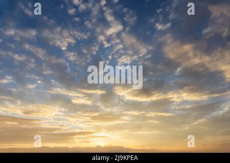 cloudscape of orange clouds on sky at sunset Stock Photo