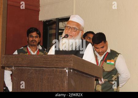 Muslim man giving a speech on a pedestal in front of an audience Stock Photo