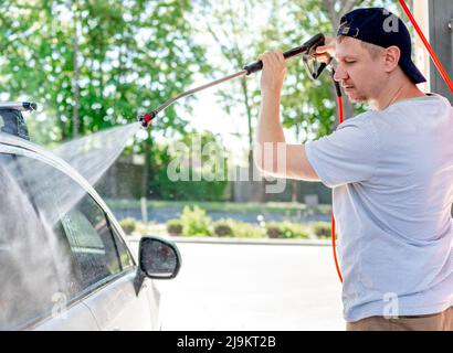 Shot of a man washing his car Stock Photo