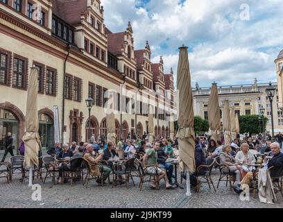 People in cafes by Leipzig's renaissance old town hall (Altes Rathaus), baroque clock tower, the local city museum during Wave-Gotik event. Leipzig. Stock Photo