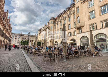 People in cafes by Leipzig's renaissance old town hall (Altes Rathaus), baroque clock tower, the local city museum during Wave-Gotik event. Leipzig. Stock Photo