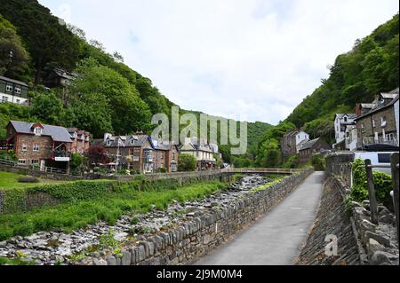 20 May 2022: Lynmouth, Devon, England, UK - A view of the River Lyn and Mars Hill on a sunny day.  Coastal village of Lynmouth in Devon on the norther Stock Photo