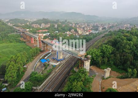 Xingye, China's Guangxi Zhuang Autonomous Region. 24th May, 2022. Aerial photo shows the girder of a swivel bridge along the Nanning-Yulin railway after rotating to its targeted position in Xingye County, south China's Guangxi Zhuang Autonomous Region, May 24, 2022. The girder of this swivel bridge rotated 57 degrees on Tuesday to its targeted position. Credit: Cao Yiming/Xinhua/Alamy Live News Stock Photo