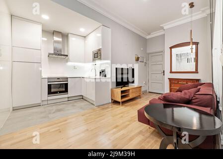 Stylish open plan kitchen with stainless steel appliances and dining ...