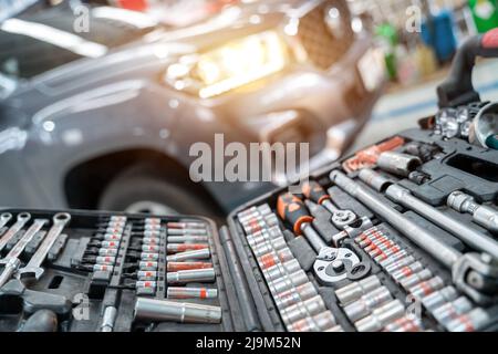 Select focus equipment or wrenches for car repairs in Car repair station. Stock Photo