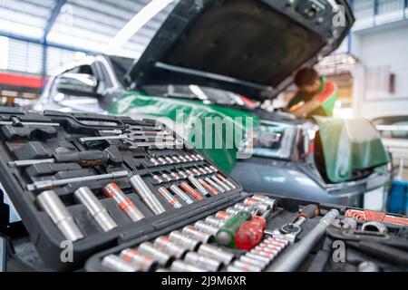 Auto mechanic working in Car repair station. Repair service. select focus equipment or wrenches for car repairs. Stock Photo