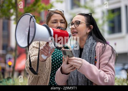 Natasha Butler (right) granddaughter of Paddy Butler who was killed during the Springhill Westrock killings, reading a statement outside the Northern Ireland Office UK Government Hub at Erskine House in Belfast, in protest on the UK Governments Troubles legacy bill. Picture date: Tuesday May 24, 2022. Stock Photo