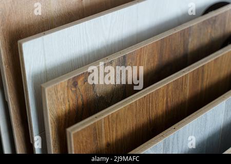 Laminate background. Samples of laminate or parquet with a pattern and wood texture for flooring and interior design. Selected focus Production of wooden floors.. . High quality photo Stock Photo