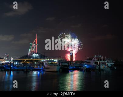 View of UAE national day celebration fireworks over Burj Al Arab hotel captured from the Burj Al Arab beach, Dubai , UAE. Stock Photo