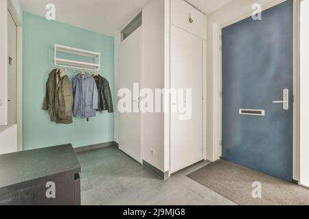 Drawers located in narrow corridor near light entrance hallway room at home Stock Photo