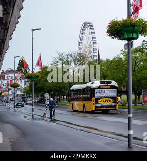 View of a giant Ferris wheel at the Hohematte park in Interlaken , Switzerland , set against a blue cloudy sky. Stock Photo