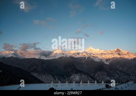 meili mountain range at sunrise with white pagodas of feilai temple in yunnan province, china Stock Photo
