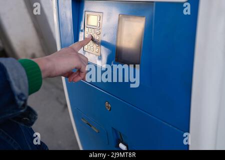 Hand is typing a pin code on ATM keyboard closeup Stock Photo
