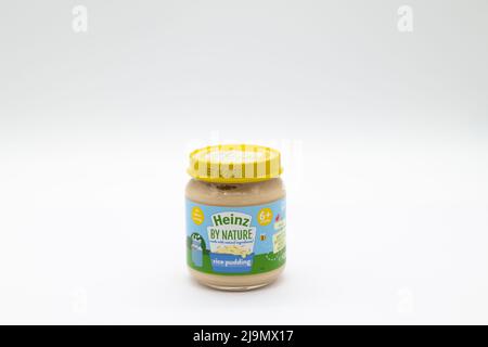 Irvine, Scotland, UK - May 18, 2022: Heinz branded baby food rice pudding in a glass jar metal lid and paper label that is recyclable. Stock Photo