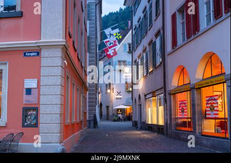 Chur, Switzerland. Picturesque view of the Chur village  with old historic buildings, alpine mountains and flowing Rhine river captured in night Stock Photo