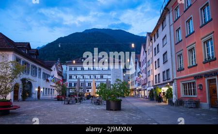 Chur, Switzerland. Picturesque view of the Chur village  with old historic buildings, alpine mountains and flowing Rhine river captured in night Stock Photo