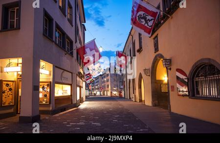 Chur, Switzerland. Picturesque view of the Chur village  with old historic buildings, alpine mountains and flowing Rhine river captured in night Stock Photo