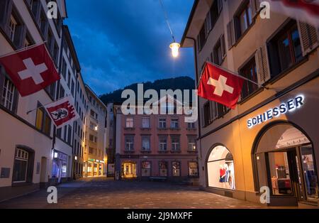 Chur, Switzerland. Picturesque view of the Chur village  with old historic buildings, alpine mountains and flowing Rhine river captured in night Stock Photo