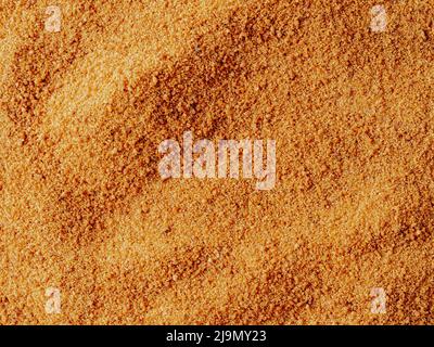 Background texture of raw organic coconut sugar from crystallized sap of cut flower buds coconut palm. Brown coconut palm sugar background topview. Alternative healthier low glycemic index sweetener Stock Photo